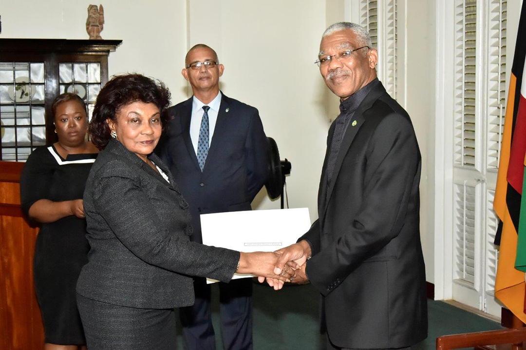 President David Granger presenting retired judge Claudette Singh with her Commission of Appointment as Senior Counsel in 2017. [Ministry of the Presidency photo) 