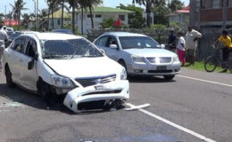 The damaged car on the East Coast Public Road after the chase. 