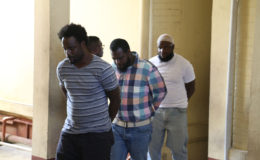 From left are Tion Alleyne, Andre Pollydore and Lloyd Roberts in court yesterday.