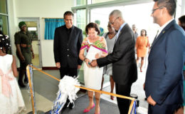 President David Granger assisting First Lady, Sandra Granger in the ceremonial ribbon-cutting to officially declare open,  Republic Bank’s Triumph Branch. They are flanked at left by Chairman of Republic Bank, Nigel Baptiste and Managing Director Richard Sammy. (Ministry of the Presidency photo) 