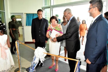 President David Granger assisting First Lady, Sandra Granger in the ceremonial ribbon-cutting to officially declare open,  Republic Bank’s Triumph Branch. They are flanked at left by Chairman of Republic Bank, Nigel Baptiste and Managing Director Richard Sammy. (Ministry of the Presidency photo) 