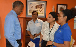 Outgoing WICB chief executive, Michael Muirhead, chats with (left to right) Cindy Grant, Dion Francis and Kevinia Francis of beverages and liquor distributors, Kennedy’s Club Limited on Tuesday. (Photo courtesy WICB)