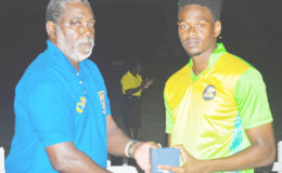BCA official Waide Bascombe presents Ronsford Beaton with the Player-of-the-Match award following the fourth round match between Guyana Jaguars and ICC Americas in Group “B” of the Regional Super50 Tournament on Monday, at the Windward Cricket Club. Photo by WICB Media/Kerrie Eversley
 