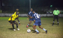 Kwesi Quintin (no.12) of Eagles trying to get pass Phillip Rowley (left) of Western Tigers while  Michael Pedro  and Clive Nobrega  watch on in the 2nd Annual Petra Organization/Limacol Football Championship at the GFC ground Bourda
