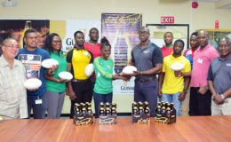 Banks DIH’s Guinness Brand Manager, Lee Baptiste along with players and the top brass of the GRFU pose for a photo opportunity yesterday following the launch of the inaugural Guinness 7s. (Orlando Charles photo)