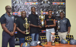 Co-Coordinator Travis Bess (center) collecting the championship trophy from Colours Boutique representative Creanna Damon while Guinness Brand Manager Lee Baptiste (left), Co-Coordinator Errol Beard (2nd from left) and Banks DIH Communications Director Troy Peters (right) look on
