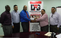 Clarence Perry Marketing manager of Demerara Mutual Life Assurance Society Limited hands over the sponsorship cheque to Drubahadur, president of the Guyana Cricket Board as from left, Colin Stuart, Anand Kalladeen and Raj Singh look on.
