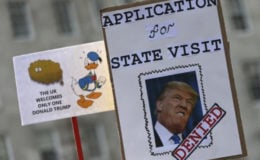 Demonstrators hold placards during a march against US President Donald Trump and his temporary ban on refugees and nationals from seven Muslim-majority countries from entering the United States, in London, Britain, February 4, 2017. (Reuters/Neil Hall)
