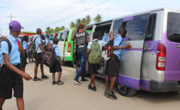 After school students from Ann’s Grove Secondary file into their respective buses.