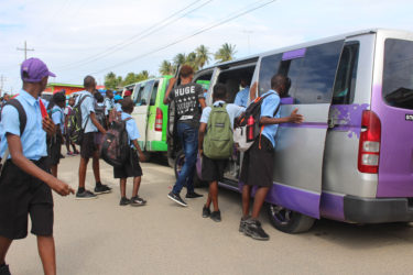 After school students from Ann’s Grove Secondary file into their respective buses.