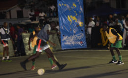 Donovan Francis (centre) of Hustlers trying to maintain possession while being challenged by a Prospect Jammers player during their matchup at the Pouderoyen Tarmac in the 3rd Annual Guinness ‘Greatest of the Streets’ West Demerara/East Bank Demerara Zone