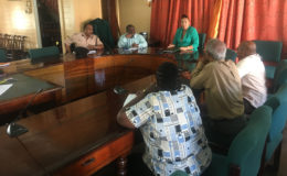 Mayor Patricia Chase-Green (at centre) along with Town Clerk Royston King (second from left) having a discussion with the Bank of Guyana representatives yesterday.
