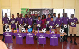 The participating schools in the 5th Annual Milo U18 Football Championship posing with their footballs, jerseys and water bottles which were donated by the Ministry of Public Health while members of the Petra Organization inclusive of Co-Director Troy Mendonca (centre) and  Ministry of Health representative Dr. Troy Sagan (2nd from left) share in the moment
