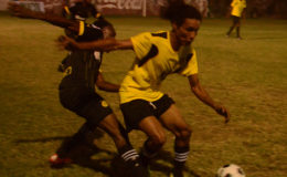 Dwayne McLennon (right) of Western Tigers battling to maintain possession of the ball while being challenged by an Uitvlugt player  at the GFC ground
