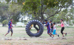 Tyre fun: Children having fun with a used tyre in the National Park. (Photo by Keno George)