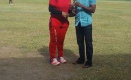 Player-of-the-match, Melanie Henry receiving her trophy from former West Indies Test batsman Shiv Chanderpaul