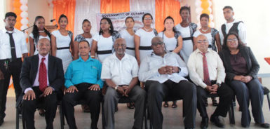 Minister within the Ministry of Social Protection Keith Scott (third from left), Regional Chairman, Region 3 Julius Faeber (second from left) and representatives of the BIT and the Leonora Technical & Vocational Training Centre surrounded by graduates of recently concluded National Training Programme for Youth Empowerment (NTPYE).
