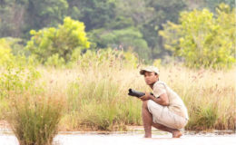 In his element- Conservation Biologist Meshach Pierre caught on the other side of the camera while preparing to make captures of his own out in the field. 