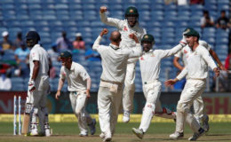 The Australian players celebrate their win in the first test match in Pune. (Reuters photo)
