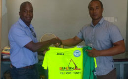 Techical Director of Victoria Kings Everald Mindy (left) receiving the newly branded kits from Devcon Construction Managing Director Nolan Lancaster.