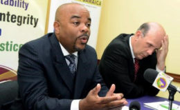 Terrence Williams (left), commissioner of the Independent Commission of Investigations, and Assistant Commissioner Hamish Campbell at a press conference at INDECOM’S head office on Dumfries Road on Monday.
