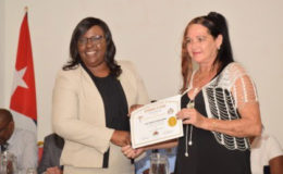 Dr. Karen Cummings (left), Minister within the Ministry of Public Health awards a certificate to Medical Laboratory Technician, Dr Ada Josefa Valides Perez (GINA photo)