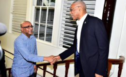 President David Granger (right) greets Opposition Leader, Bharrat Jagdeo on his arrival at State House last evening. (Ministry of the Presidency photo)