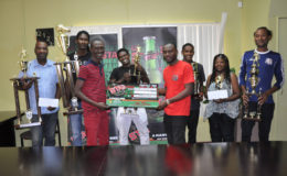Western Tigers head-coach Calvin Allen (3rd from left) collects the winner’s cheque from Stag Brand Assistant Keon Persaud in the presence of members from Western Tigers, Santos and Riddim Squad.
