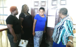 Petronella Trotman (third from left) standing outside of the courtroom of Magistrate Dylon Bess after she was ordered to leave.