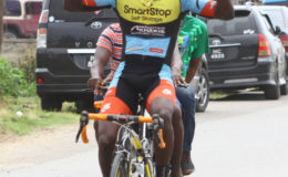 Shaquel Agard celebrates his first signature win for the season. The Cheddi Jagan Memorial road race was staged yesterday in Berbice. (Orlando Charles photo)