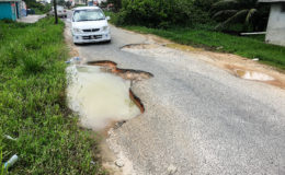 These two large potholes make it very difficult to drive along the road as drivers are forced to carefully manoeuvre to the middle of the road.