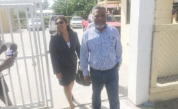 Former Prime Minister Sam Hinds and his attorney Priya Manickchand leaving SOCU Headquarters yesterday.