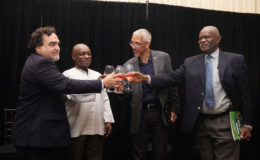 Chilean Ambassador Carlos Rojas (first left), Minister of Foreign Affairs Carl Greenidge (second left), Minister of Business Dominic Gaskin (second right) and Minister of Citizenship Winston Felix in a ceremonial toast at the launch of the Guyana/Chile visa waiver agreement at the Marriott Hotel last evening. 