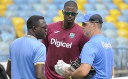 IN A HUDDLE: West Indies captain Jason Holder (centre) listens on as convenor of selector, Courtney Browne (left) and head coach Stuart Law converse during a training session yesterday. (Photo courtesy WICB Media)