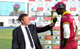 A dejected-looking West Indies captain Jason Holder speaks to interviewer Ian Ward following the regional side’s 186-run defeat to England on Thursday. (Photo courtesy WICB  Media) 