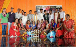 Members of the Golden Om Dharmic Youth Organisation pose with trophies they won at a past event.