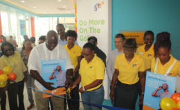 GTT CEO Justin Nedd (left) and the store manager Kriz Glasgow cutting the ceremonial ribbon at the official opening of the customer experience store at the corner of Camp and Robb streets.
