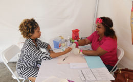 A young woman has her blood sugar tested at  the Women’s Health Fair on Friday.
