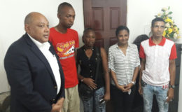AFC Leader Raphael Trotman (left) with those who suffered losses (AFC photo)
