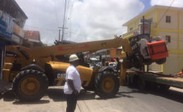 City Building Inspector Marlon Harris looks on as the loader is removed
