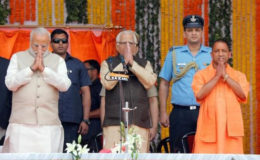 Prime Minister Narendra Modi (L), Uttar Pradesh governor Ram Naik (C) and Bharatiya Janata Party (BJP) leader Yogi Adityanath (R) greet a gathering before Adityanath takes an oath as the new Chief Minister of India’s most populous state of Uttar Pradesh during a swearing-in ceremony in Lucknow, India, March 19, 2017. REUTERS/Pawan Kumar
