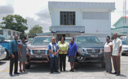 The two vehicles can be seen here with staff of the ministry and others (Ministry of Public Health photo)