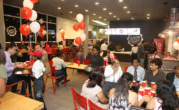 A section of the crowd that gathered to sample the food being offered by the newly-introduced franchise, Johnny Rockets, at a special pre-launch event on Monday evening. (Keno George photo)
