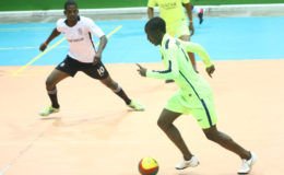 Back Circle’s Stephon McLean (right) on the attack while being pursued by Delroy Dotson of Agricola at the National Gymnasium ( Orlando Charles photo)