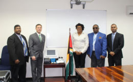 Minister within the Ministry of Public Infrastructure Annette Ferguson (third right) and Terry Steers-Gonzalez, Deputy Chief of Mission of the United States Embassy, (second left) with the equipment following the simple handing over ceremony. With them are Lt Col (Ret’d) Lawrence London, Chairman of the GCAA’s Board (second right); Abraham Dorris, Manager of the Aviation Security Department of the GCAA (first left); and Alvin Majeed, Airport Security Manager of CJIA. (Ministry of Public Infrastructure photo)