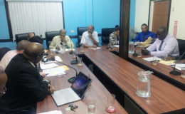 Chairman of the Public Utilities Commission (PUC) Prem Persaud (at centre) along with representatives from both companies. 