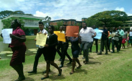 Workers marching on the second day of protests by the unions representing University of Guyana workers. 