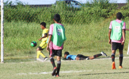 Tyrell Khan (yellow) of Chase Academy scoring against South Ruimveldt during their round of 16 clash in the Milo U18 Secondary School Football Championship at the Ministry of Education ground