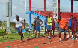 FIFA referee Venton Mars (left) going through his paces alongside another referee while other officials wait in queue at the National Track and Field Centre, Leonora. 