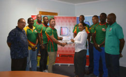 National rugby 7s captain, Ryan Gonsalves collecting the sponsorship cheque from Edward B. Beharry and Companies, Brand Manager, Monique Tiwari in the presence of his charges and GRFU President, Peter Green and Coach, Shane Grant-Stuart.